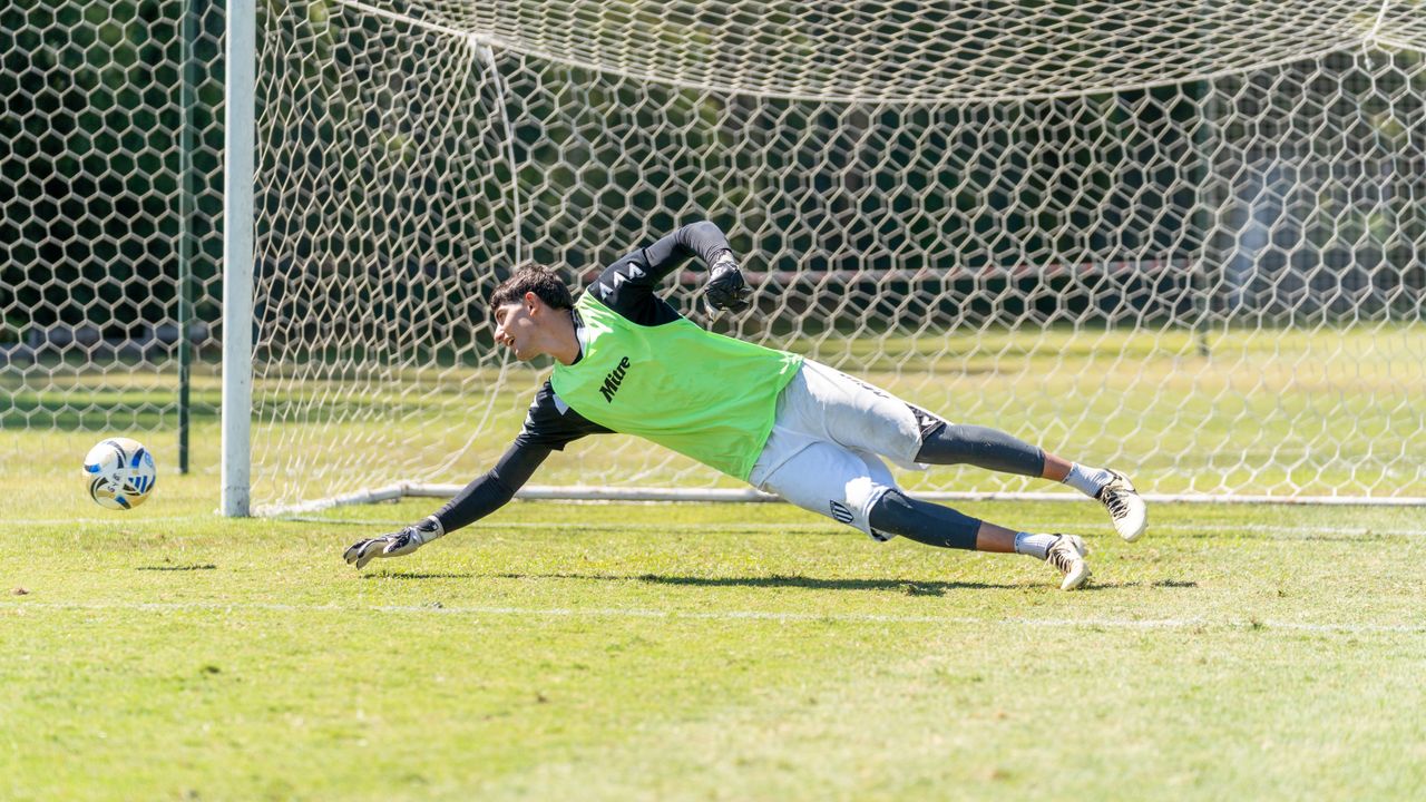 The Art of Drawing Readers In: Your attractive post title goes here Athletic goalkeeper diving to stop a soccer ball during a sunny outdoor game.